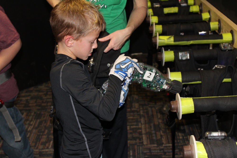 Kid checks out laser gun